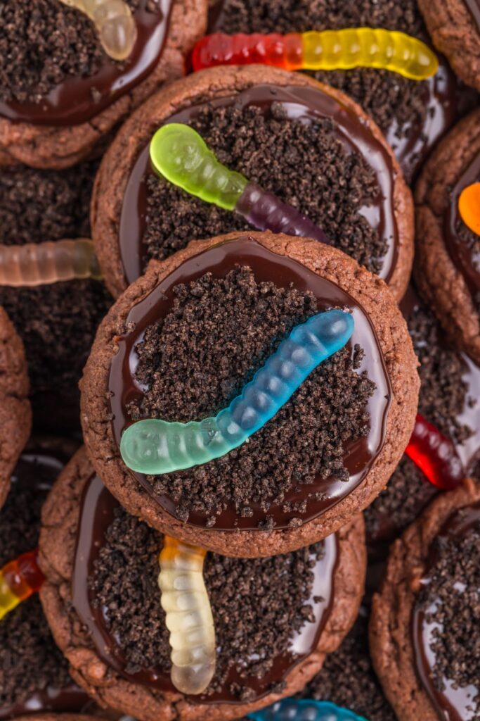 Pile of cookies with Oreo dirt and gummy worm candies.