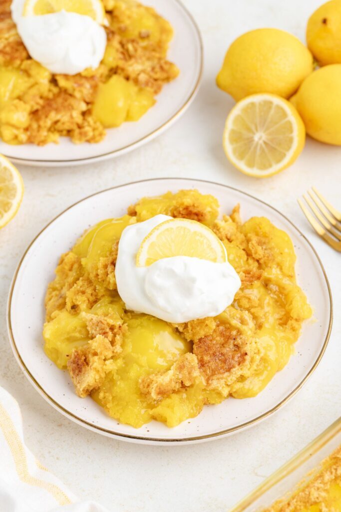 Three ingredient lemon dump cake with whipped cream.