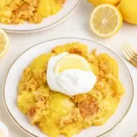 Three ingredient lemon dump cake with whipped cream.