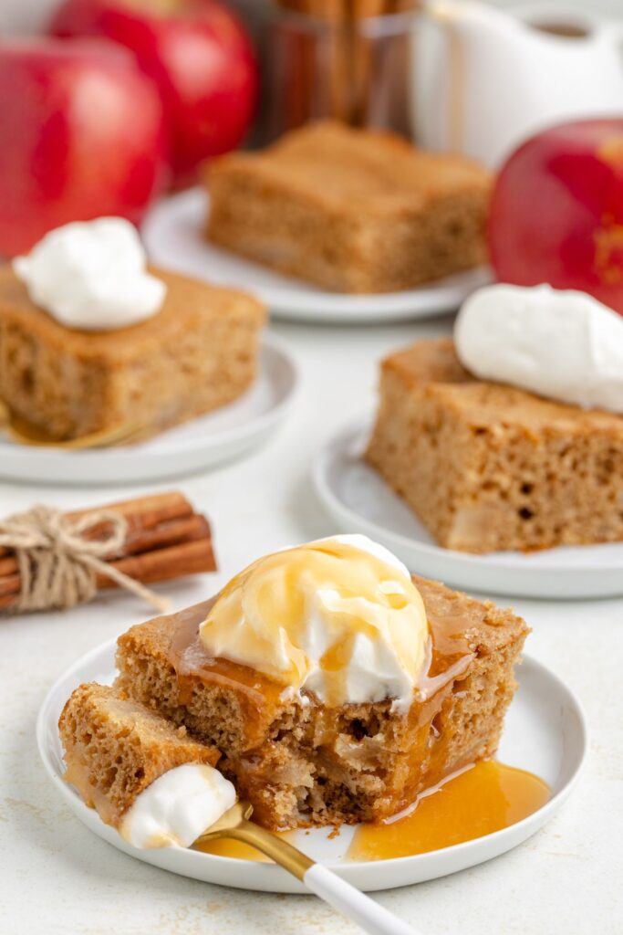 Forkful of 3 ingredient apple spice cake with caramel sauce.