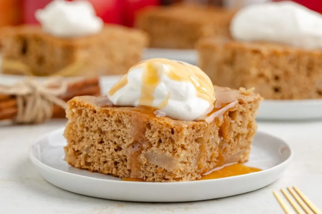 Whipped cream topped three ingredient apple cake.