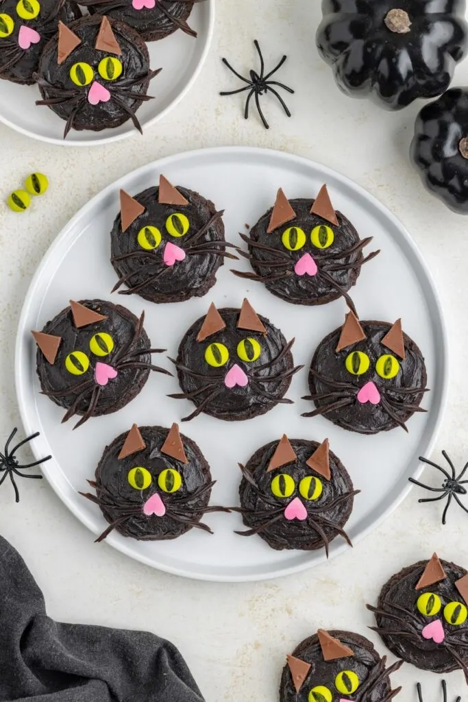 Plate of black cat face cookies.