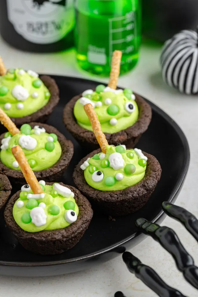 Cauldron cookies with green frosting and sprinkles.