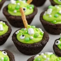 Cauldron cookies with frosting and Halloween sprinkles.