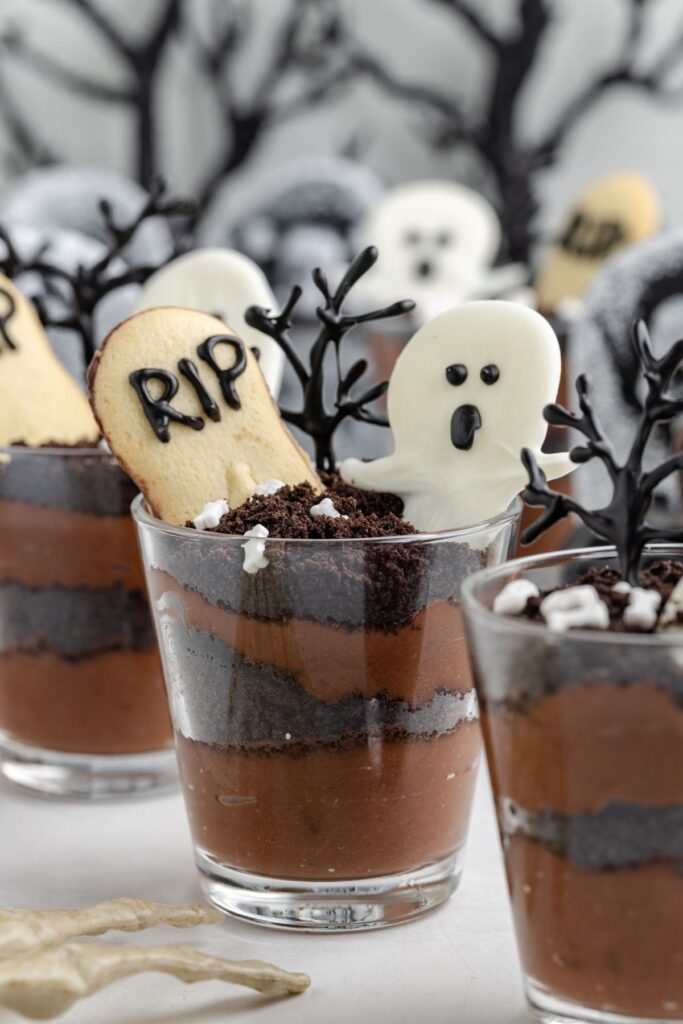 Graveyard pudding cups with tombstones and ghosts.