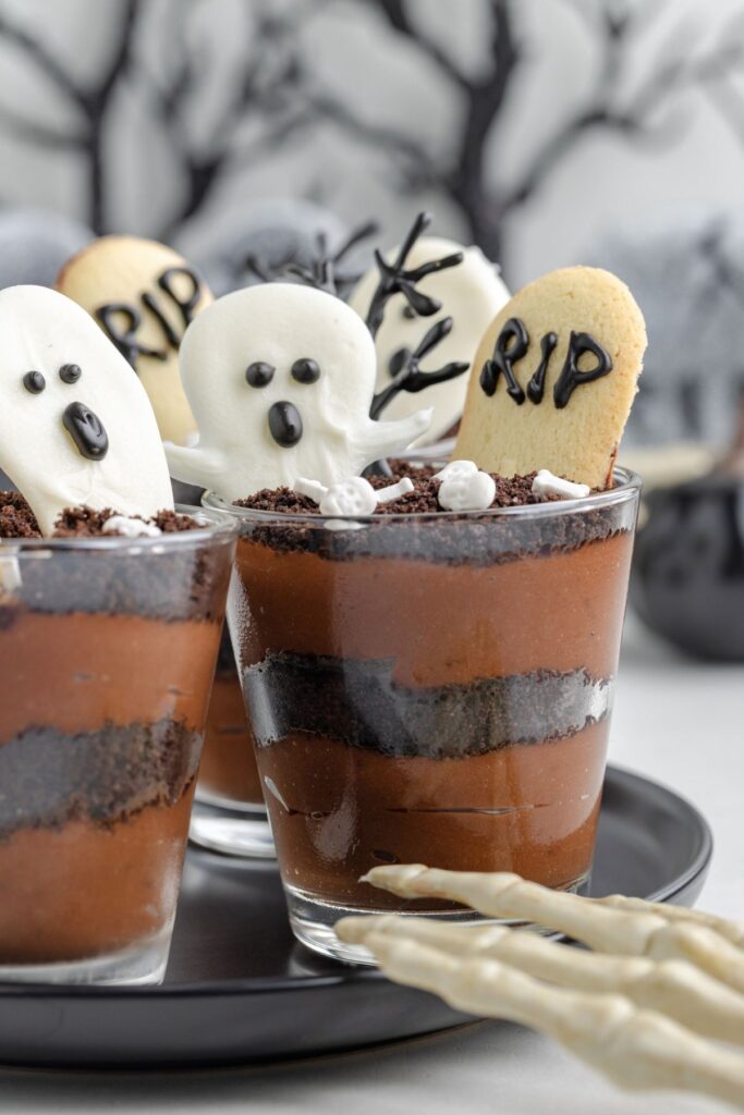 Graveyard chocolate pudding cups with ghosts and tombstones.