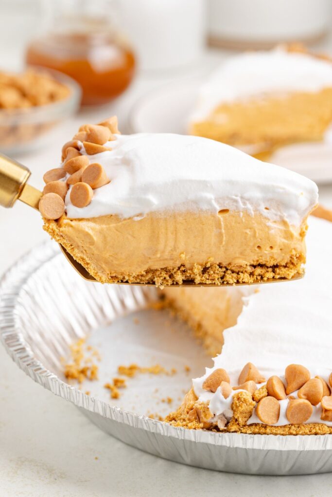 Slice of butterscotch pudding pie being removed from the pan.