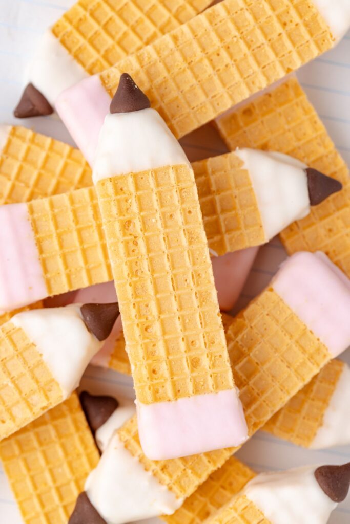 Pile of wafer cookies decorated as pencils.