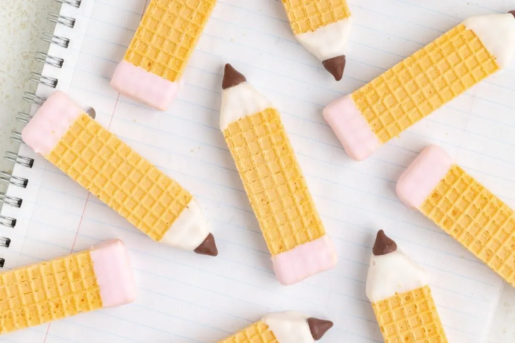 Wafer cookies arranged on a notebook.