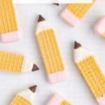 Wafer cookies look like pencils with pink and brown icing on lined paper. Text: Pencil Cookies, Fun Back-to-School Recipe.