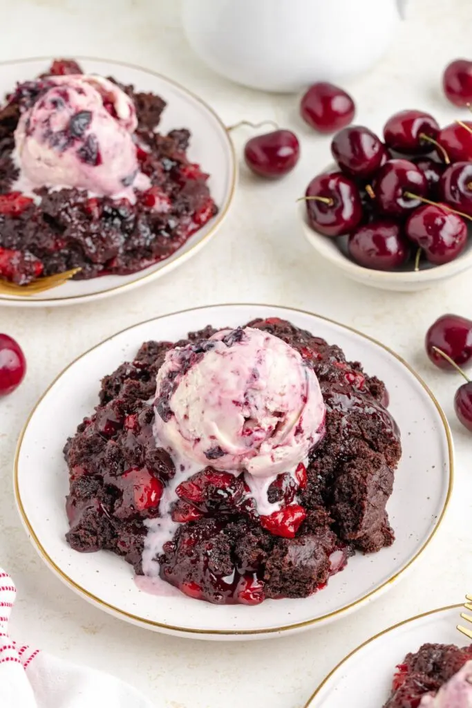 Chocolate cherry dump cake topped with ice cream.