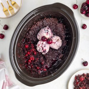 Slow cooker cherry chocolate dump cake with ice cream.