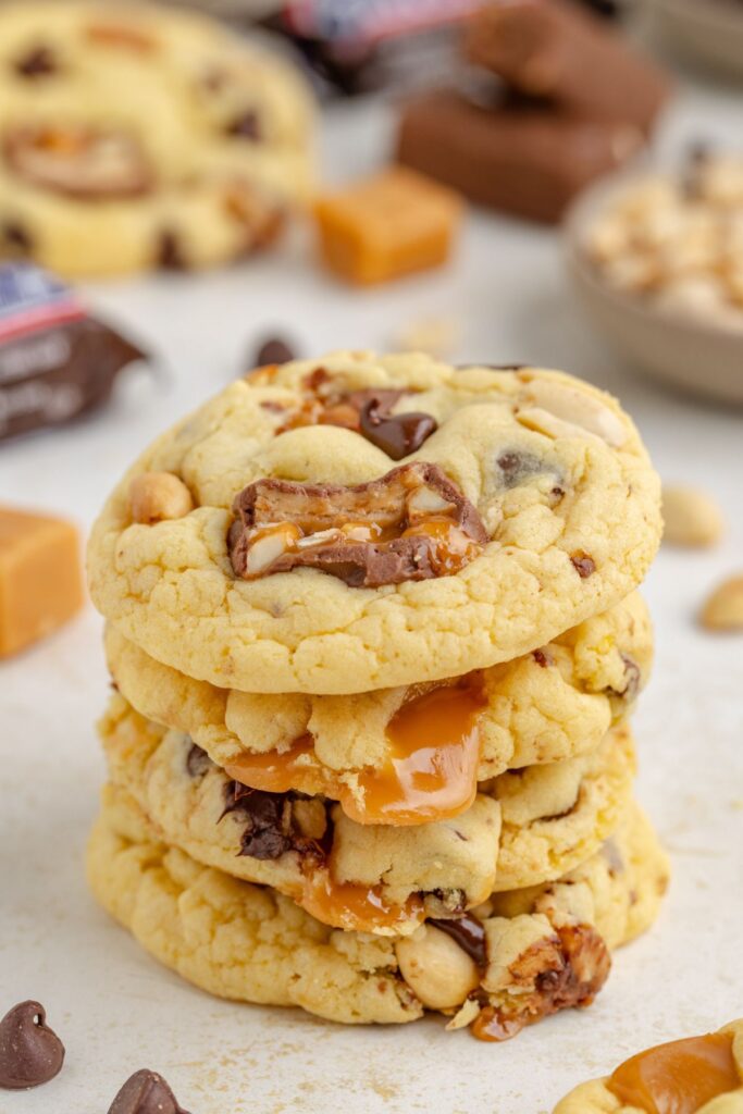 Stack of four cookies with Snickers candy bars.