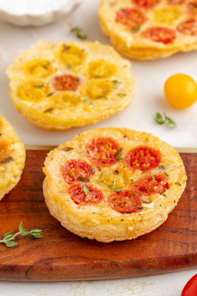 Upside down puff pastry tarts with cherry tomatoes.