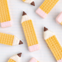 Pencil wafer cookies displayed on a notebook.