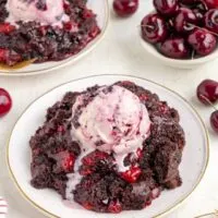 Chocolate cherry dump cake topped with ice cream.