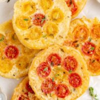 Pile of Tomato Upside Down Puff Pastry Tarts with gruyere cheese.