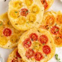 Pile of Tomato Upside Down Puff Pastry Tarts with gruyere cheese.