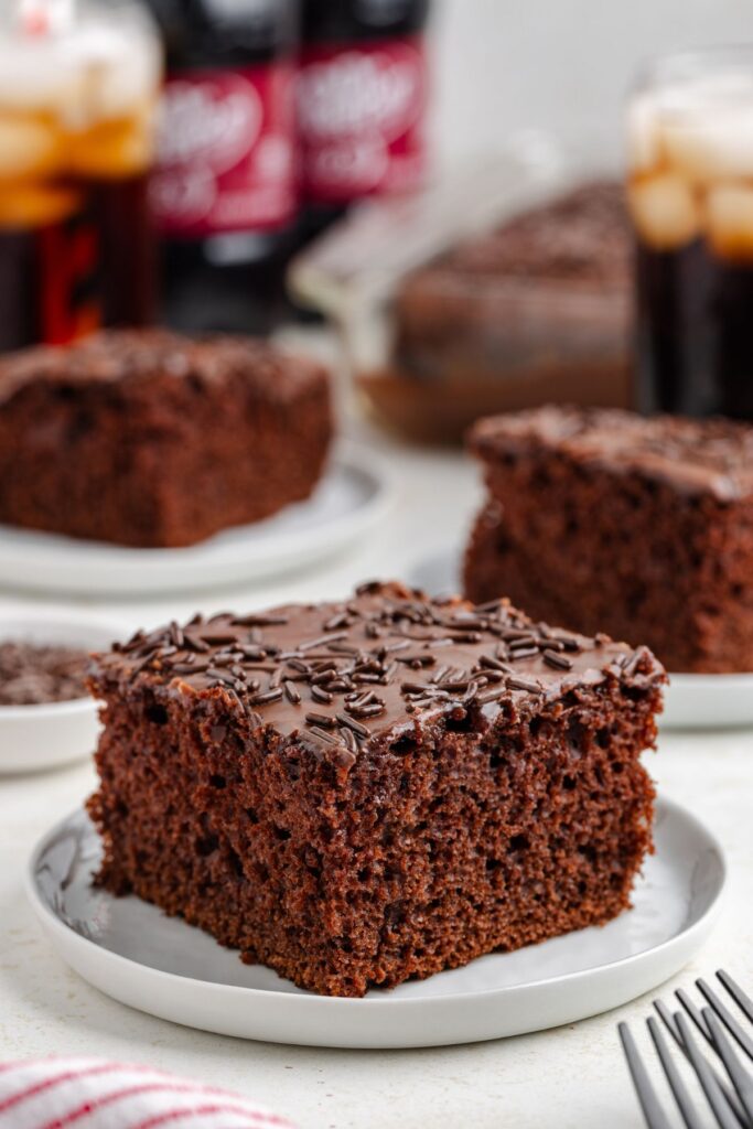 Slice of Dr Pepper cake made from cake mix on a white plate.