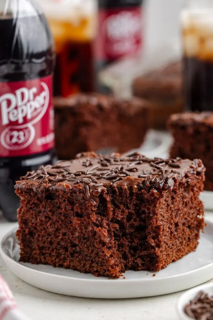 Slice of Dr Pepper cake with a forkful of cake missing.