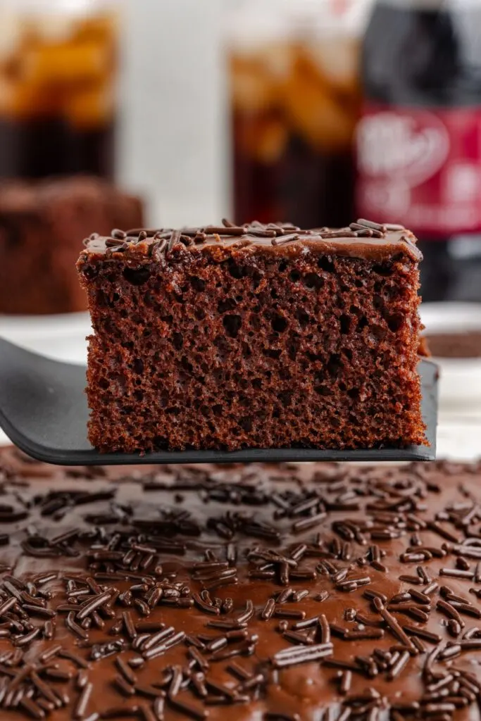 Slice of cake mix Dr Pepper cake being removed from the pan.