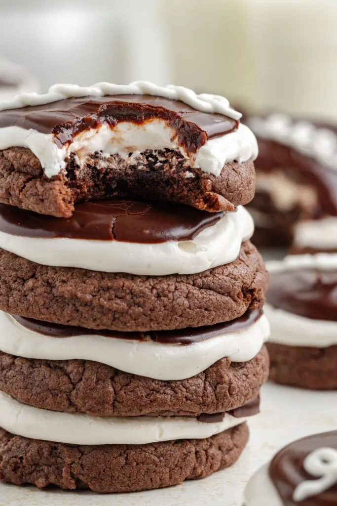 Four Hostess cookies stacked with a bite missing from the top cookie.  