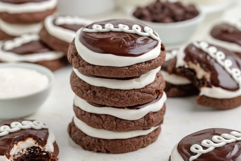 Stack of chocolate cake mix cookies with marshmallow frosting and chocolate ganache. 