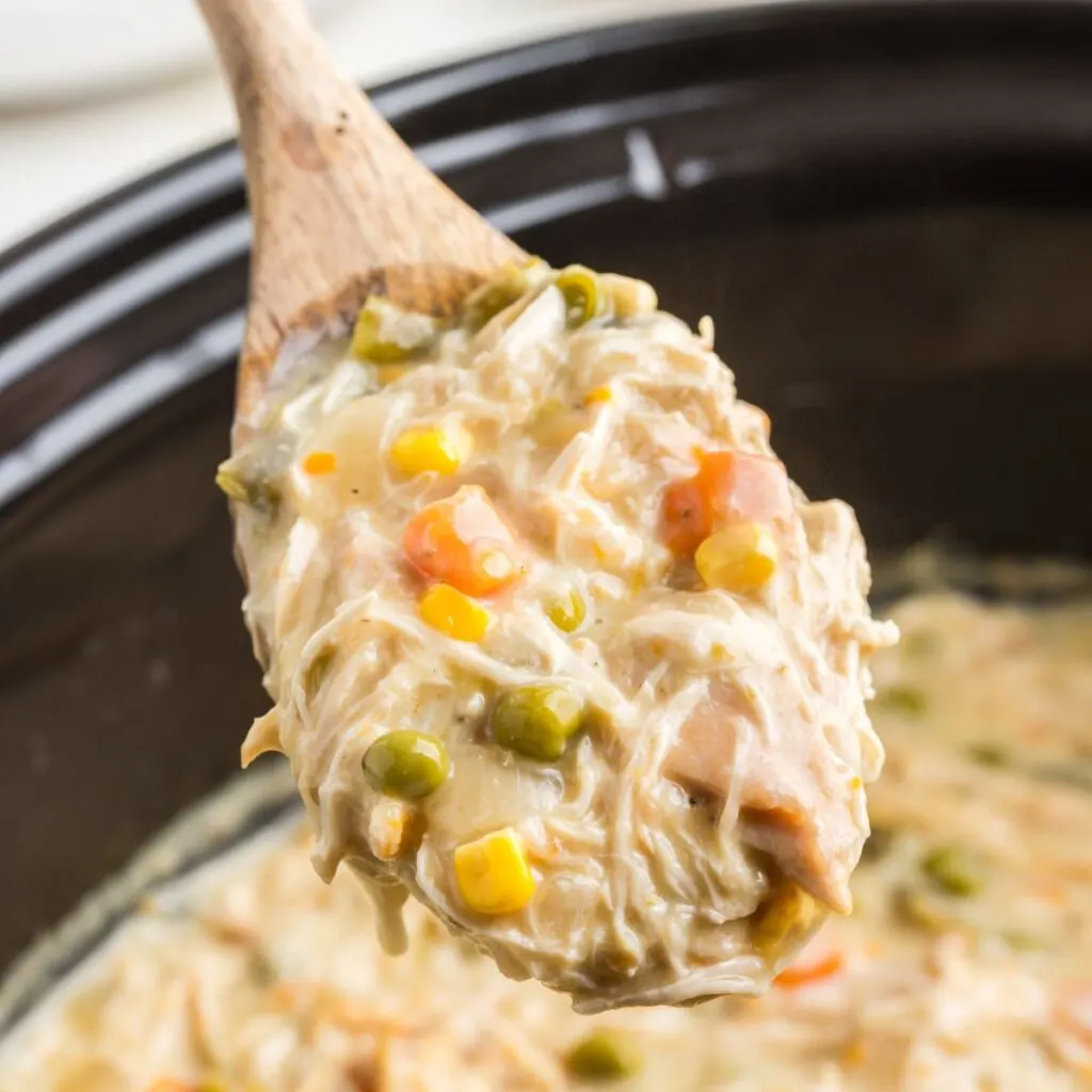 Spoonful of creamy crockpot chicken pot pie.