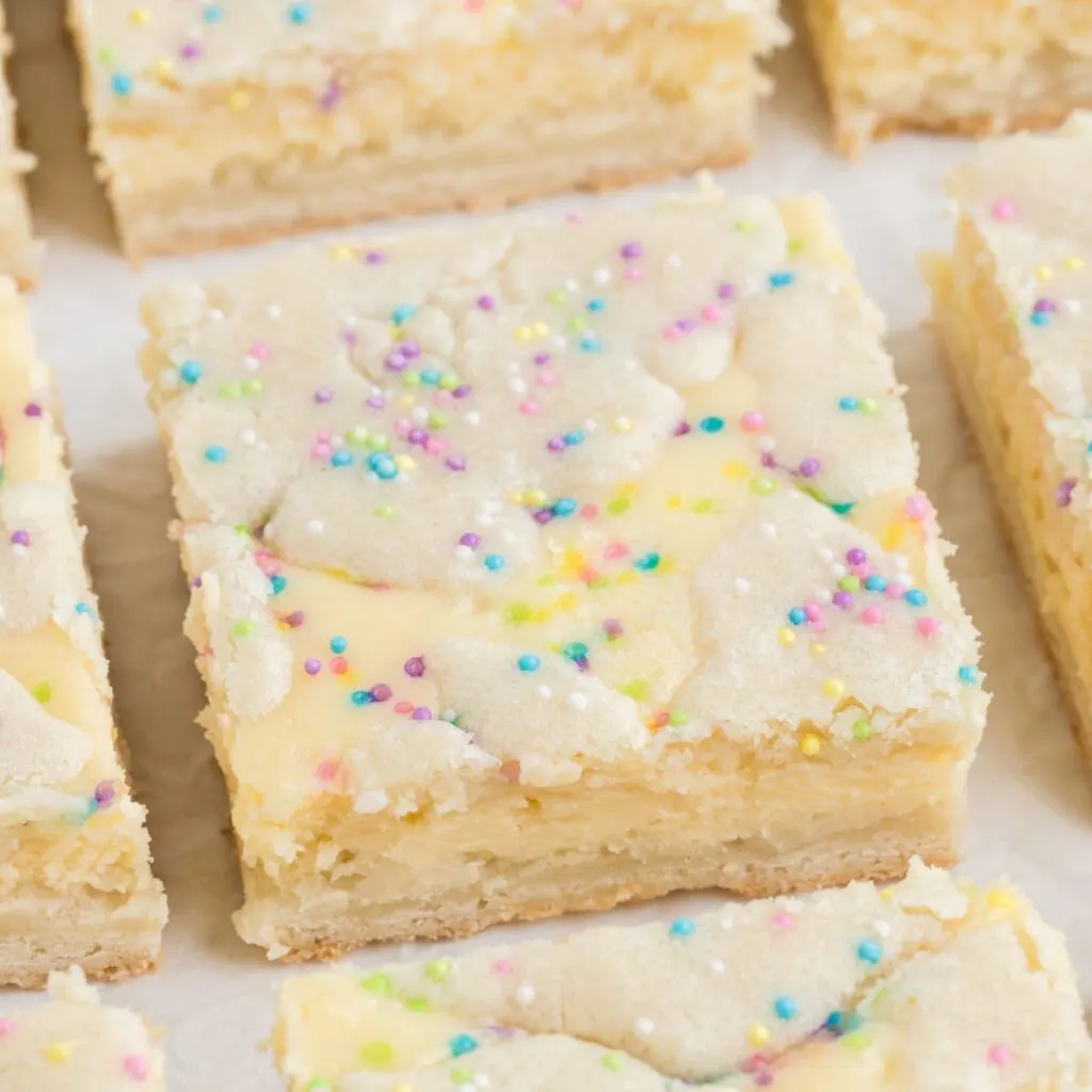 Sugar cookie cheesecake bars with sprinkles.