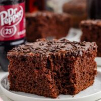 Slice of Dr Pepper cake with a forkful of cake missing.