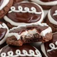 Pile of Hostess cupcake cookies with a bite missing from one cookie.