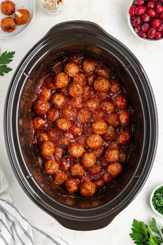 Slow cooker full of meatballs in cranberry chili sauce. 