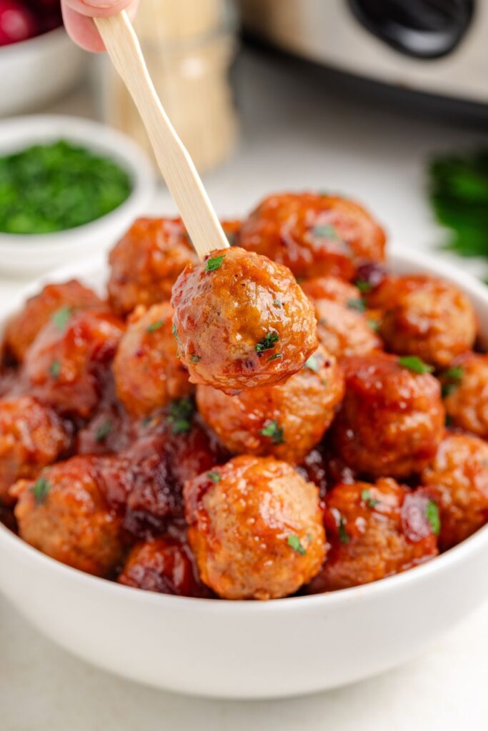 Cranberry meatball on a wooden toothpick.