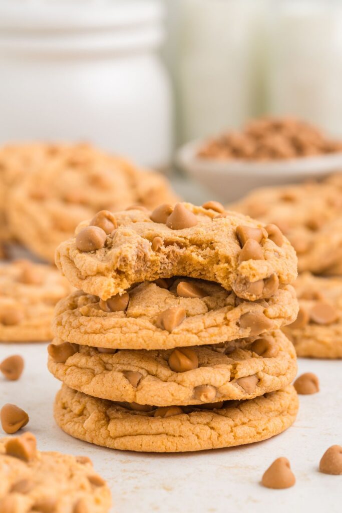 Stack of four cake mix butterscotch pudding cookies with bit taken out of the top cookie.