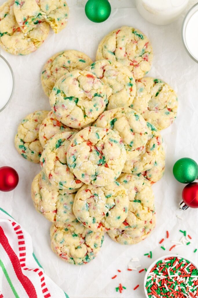 Gooey butter cookies with red and green sprinkles piled on the counter.