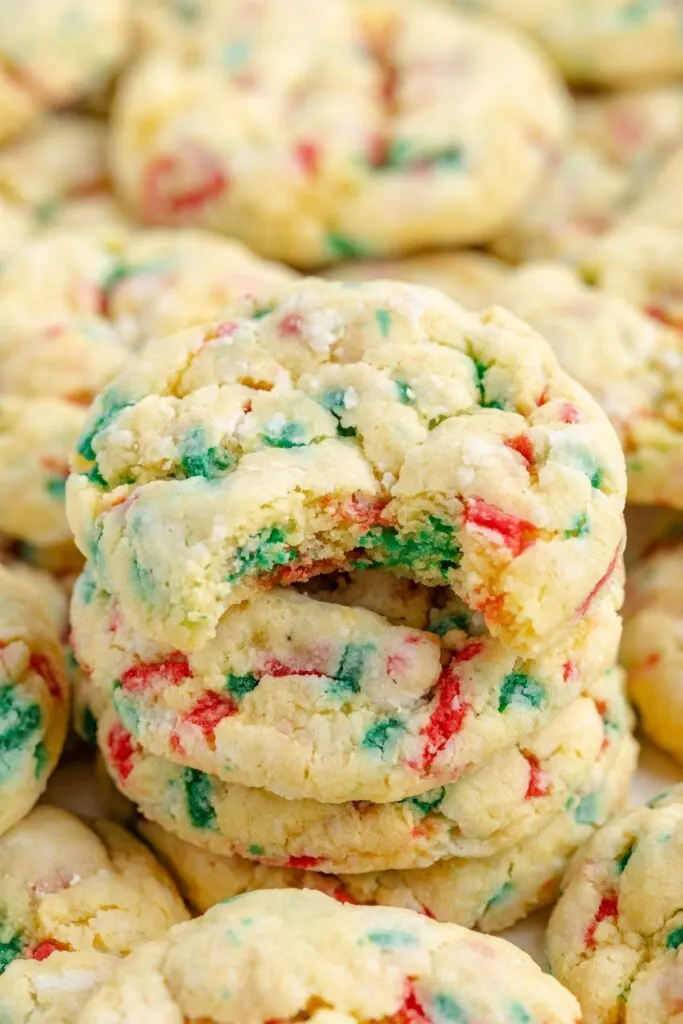 Stack of gooey butter Christmas cookies with a bite missing from the top cookie.