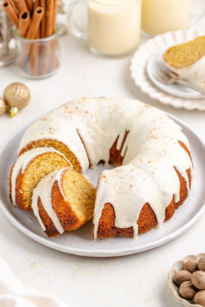 Eggnog bundt cake on a plate with eggnog glaze.