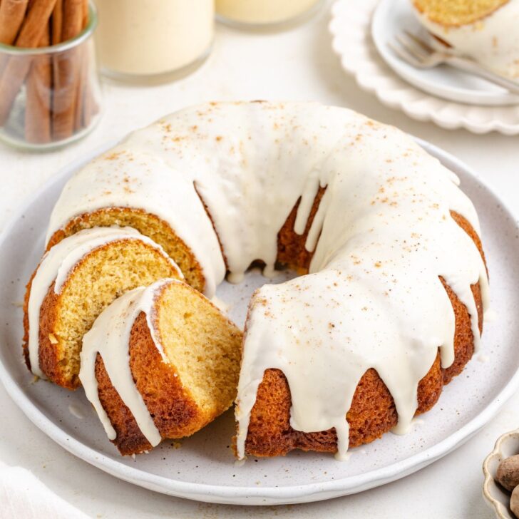 Eggnog bundt cake with eggnog glaze on a plate.