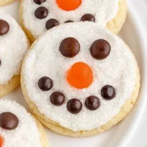 Cute frosted snowman face cookies with candy.