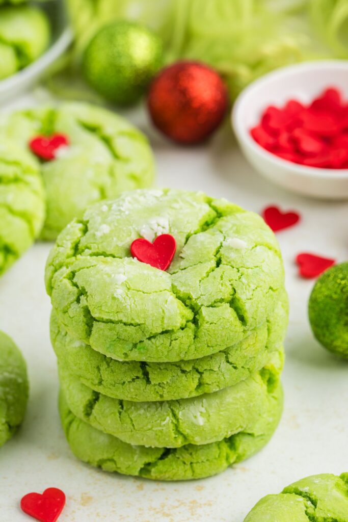 Stack of four cake mix Grinch cookies on the counter.