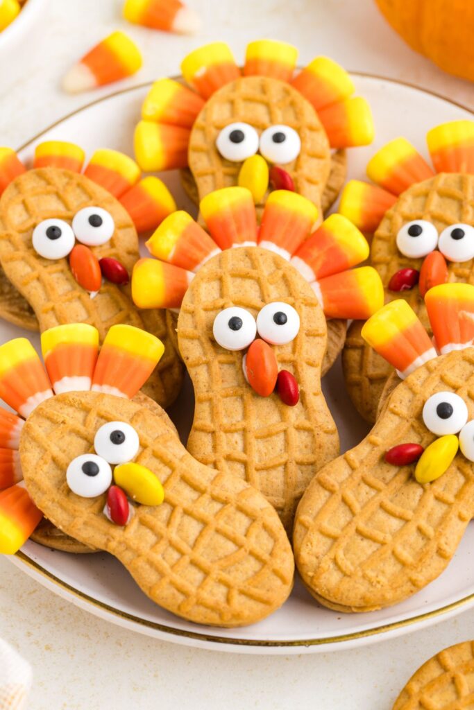 Cute Nutter Butter turkey cookies with candy decorations on a plate.