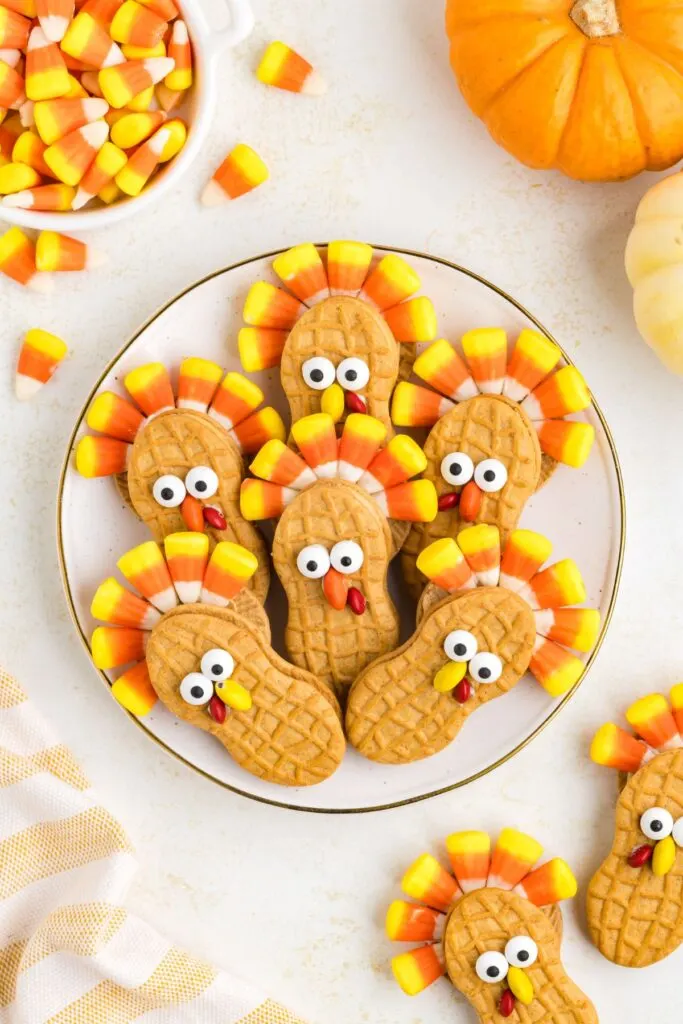 Plate of Nutter Butter cookies with candy corn tails.