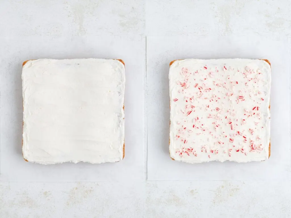 Two square cookies on a white surface. The left cake is covered with plain white frosting. The right cookie has white frosting with bits of crushed red peppermint candy sprinkled on top.