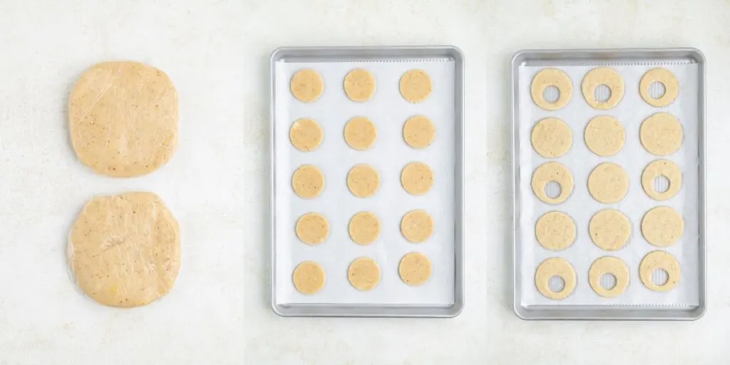 Two discs of cookie dough on the left, a tray with circular dough cutouts in the middle, and another tray on the right with circular cutouts and some with inner circles removed. All are on a light background.