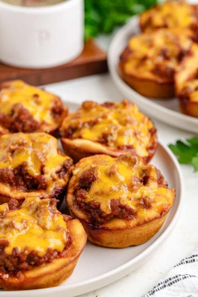 Plate of sloppy Joe muffins topped with melted cheese.