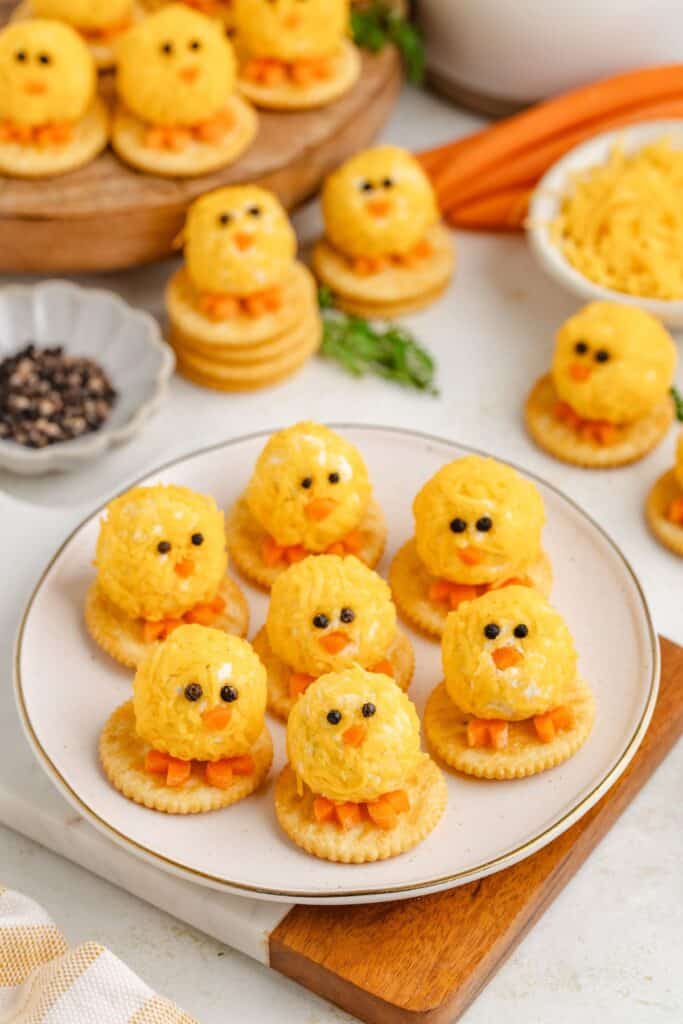 Plate of mini cheese ball chicks on Ritz crackers for Easter.
