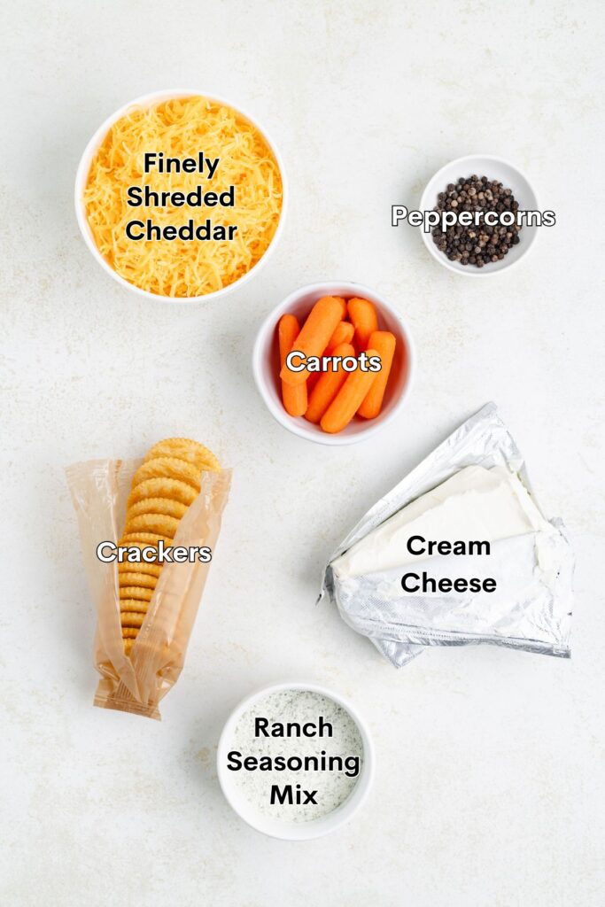 Assorted ingredients: cheddar, peppercorns, carrots, crackers, cream cheese, ranch mix.