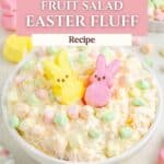 Easter Fluff fruit salad in a bowl, topped with pastel mini marshmallows and bunny candies.