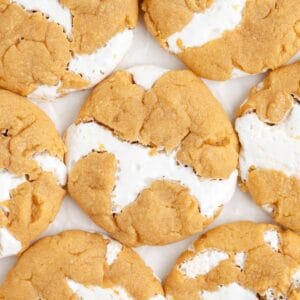 Close-up of golden-brown Fluffernutter Cookies with marshmallow filling, arranged in a grid on white.