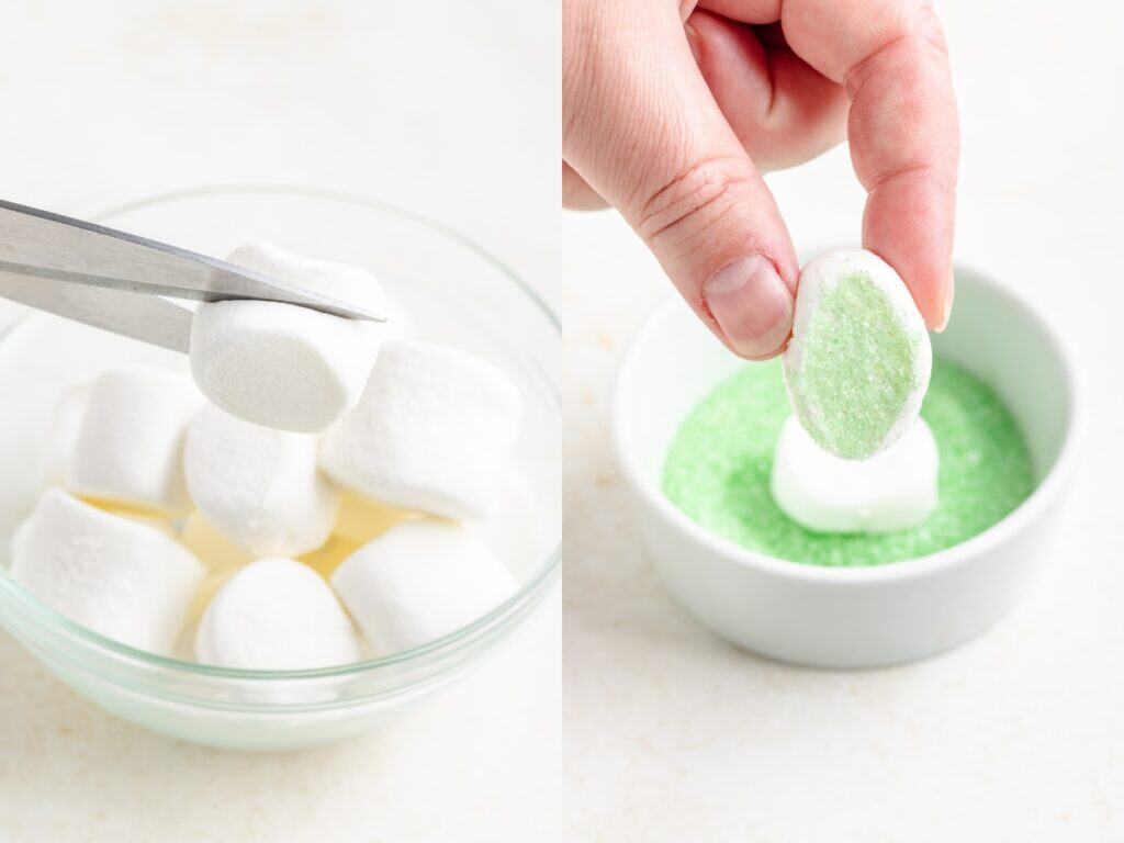 Person slices marshmallow, dips it in green sugar; bowl of whole marshmallows sits behind.